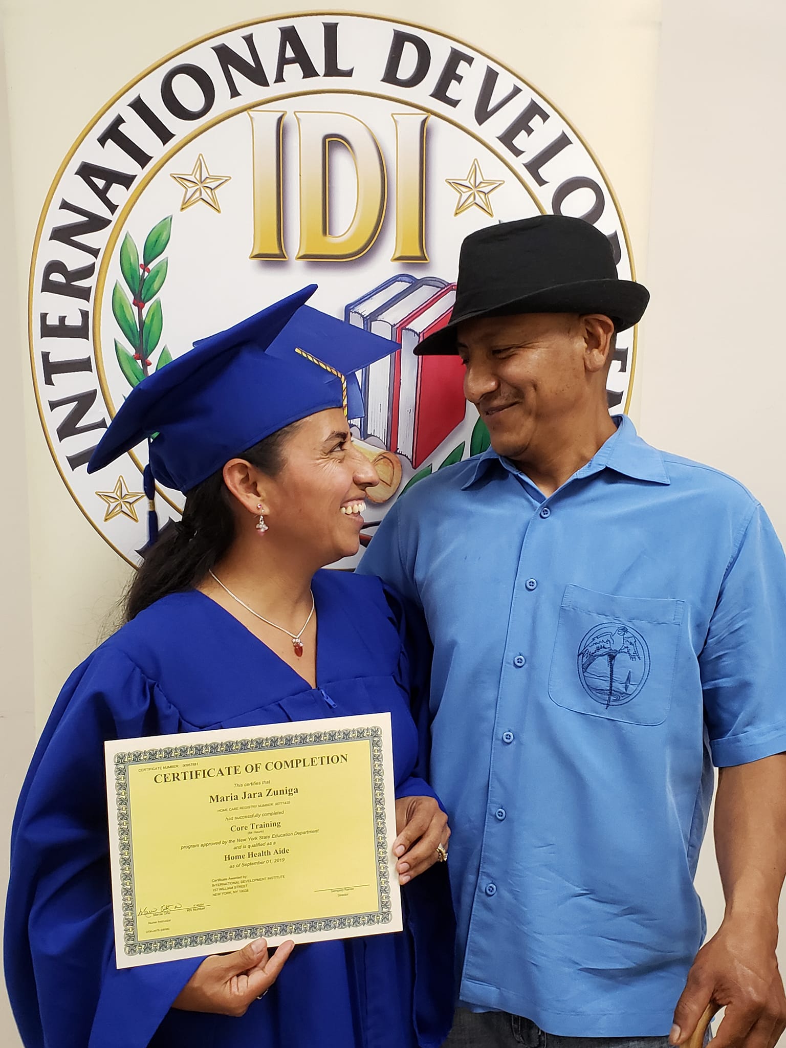 International Development Institute graduate displaying her certificate