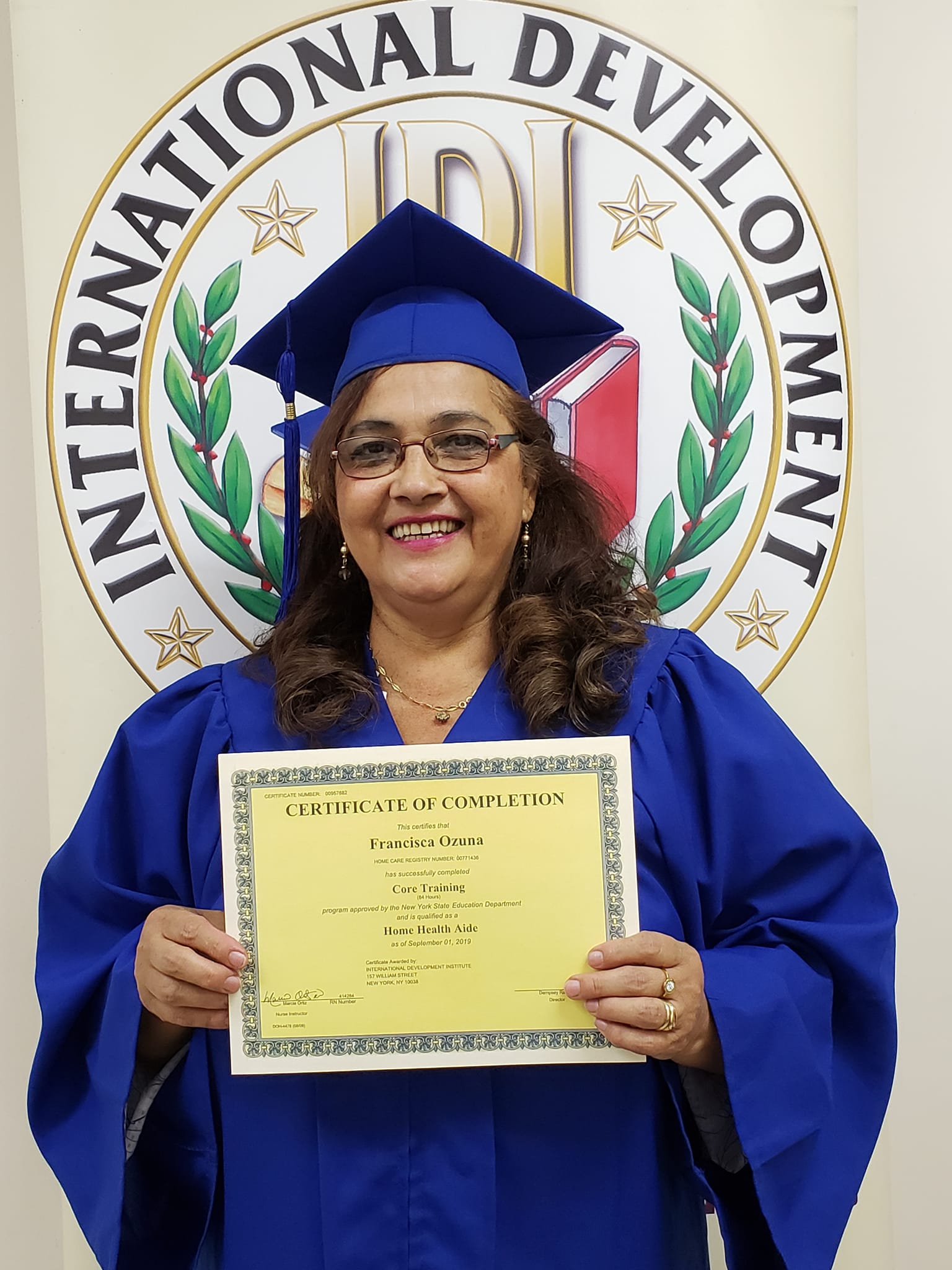International Development Institute graduate holding her certificate